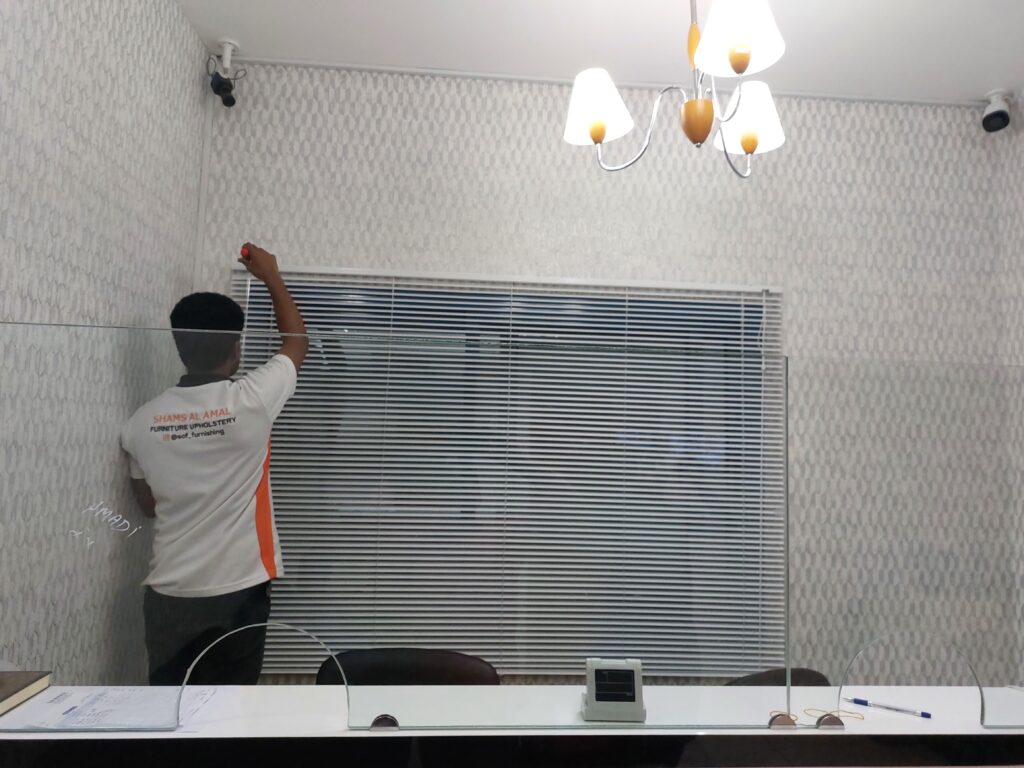 Blind installation progress in the office.
